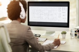 black-woman-with-headphones-working-at-computer-at-2023-11-27-05-05-34-utc